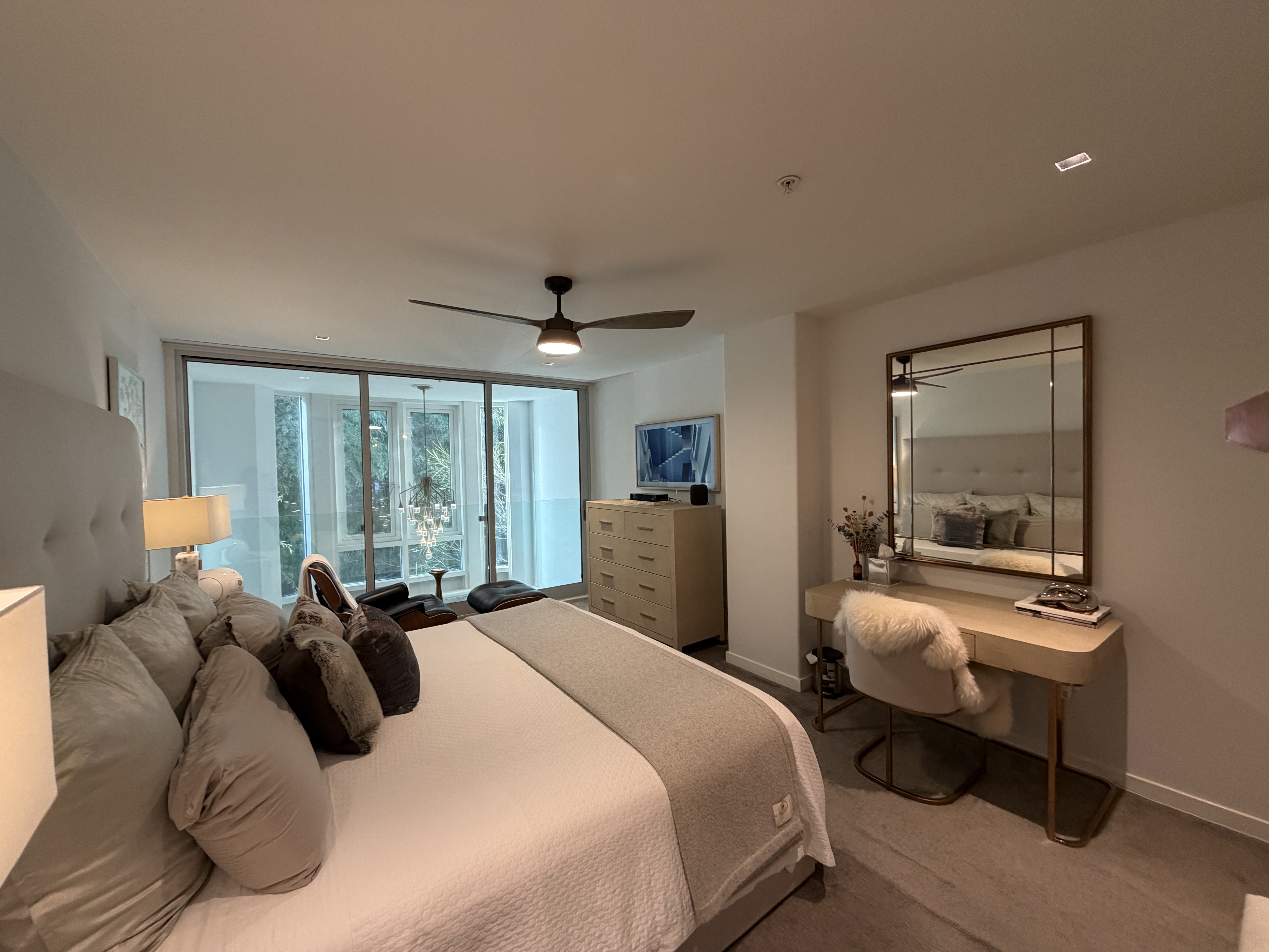 Panoramic bedroom with desk area and smart TV